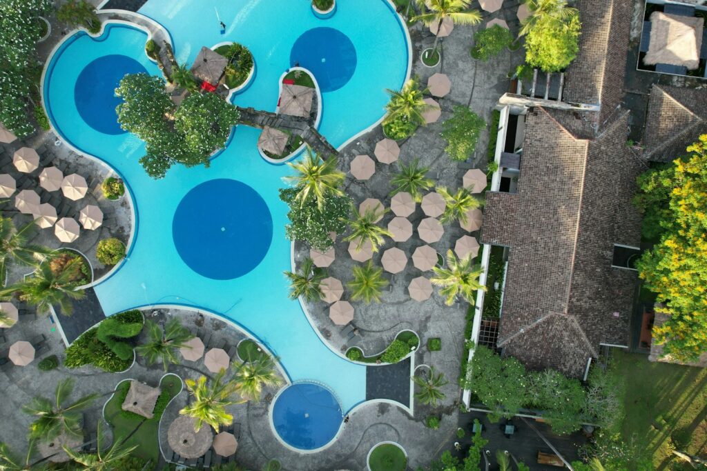 An aerial view of a pool surrounded by trees