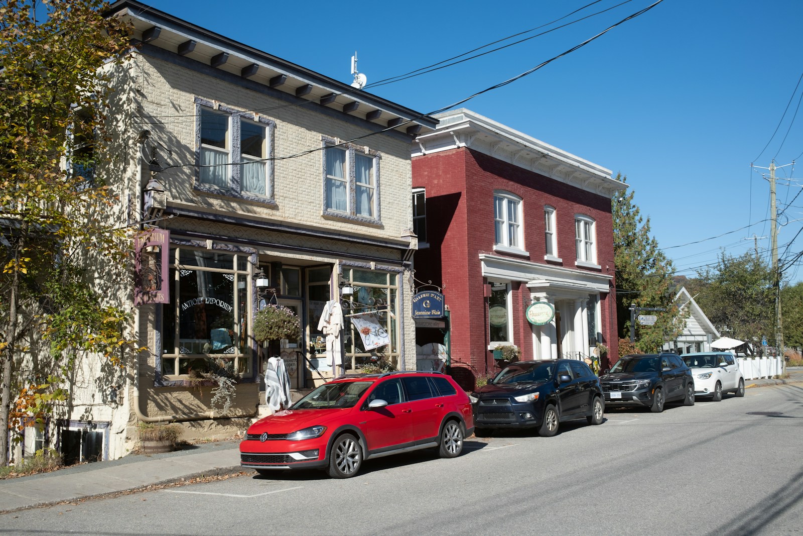 A red car parked in front of a building