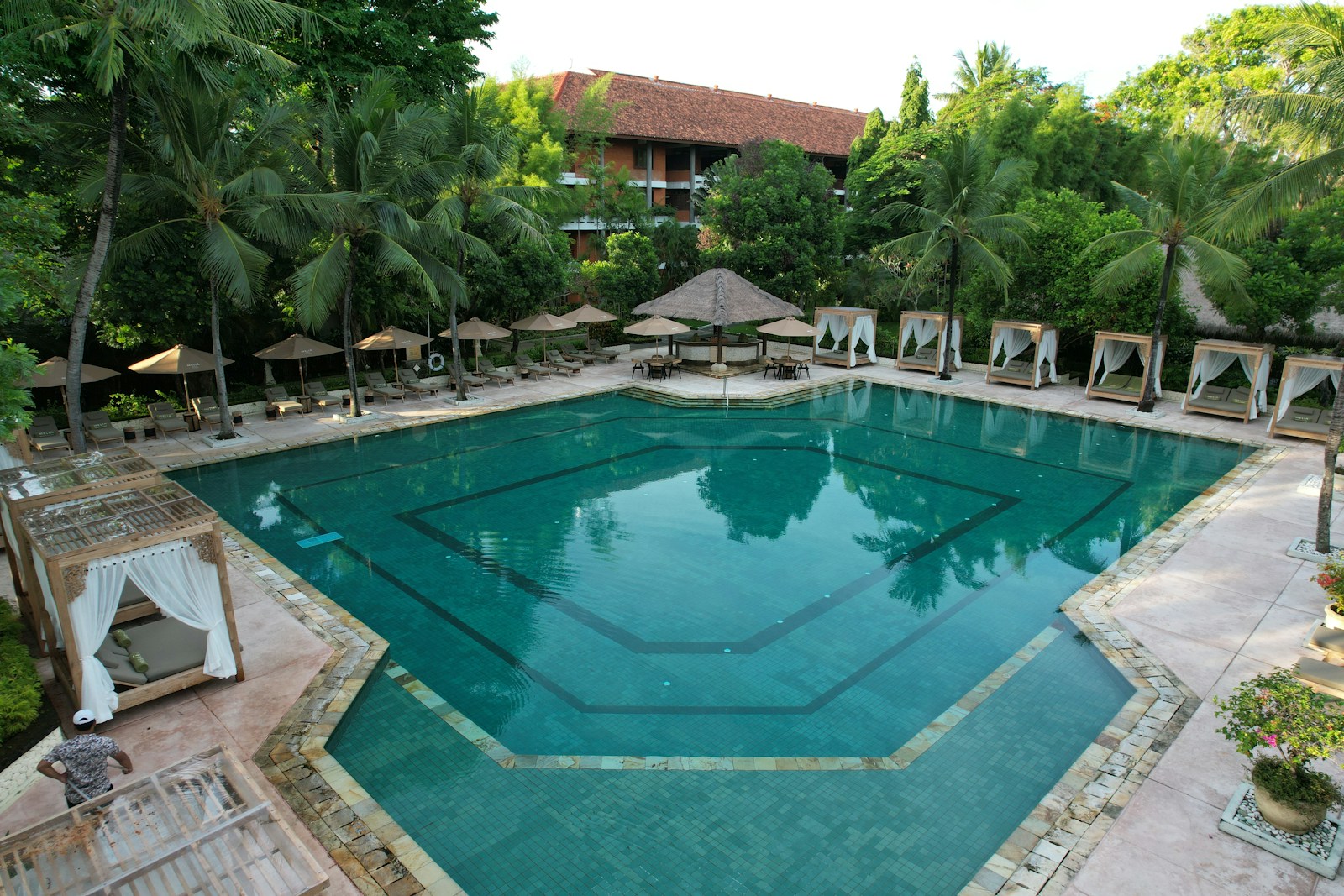 A large swimming pool surrounded by lawn chairs